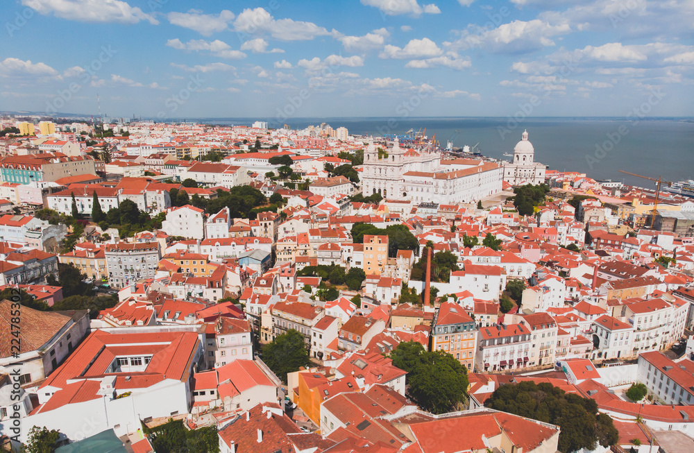 Beautiful super wide-angle aerial view of Lisbon, Portugal with harbor and skyline scenery beyond the city, shot from drone
