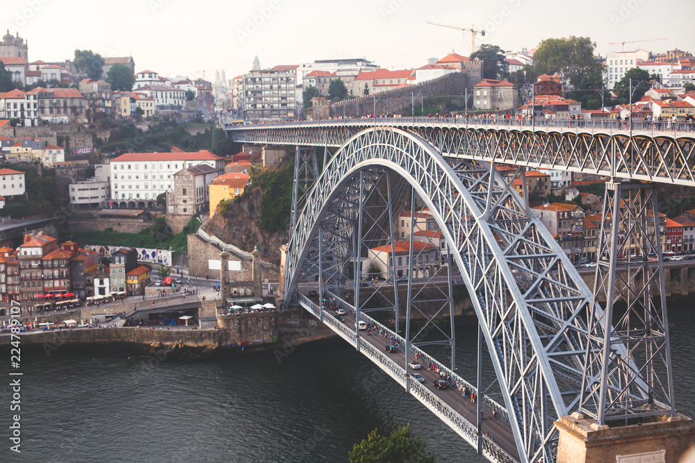 Beautiful super wide-angle summer aerial view of Porto, Portugal, with Douro river and famous view of Dom Luis I Bridge in Porto skyline and scenery beyond the old town, during the sunset