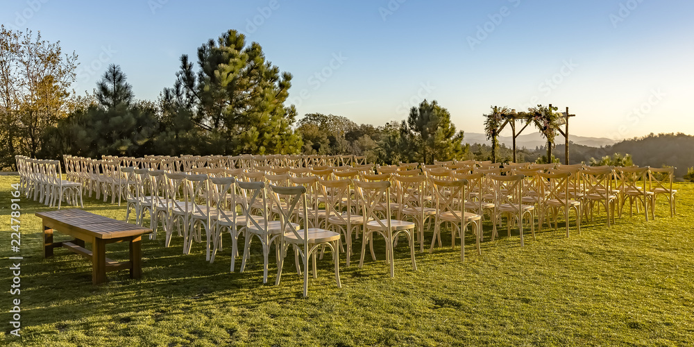 Chairs and Chuppah on a lawn with stunning view
