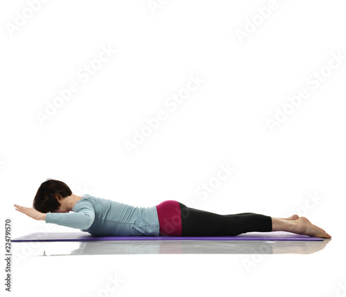 Woman exercising doing postnatal workout. Female fitness stretching hands legs abdominal exercises in gym work out 