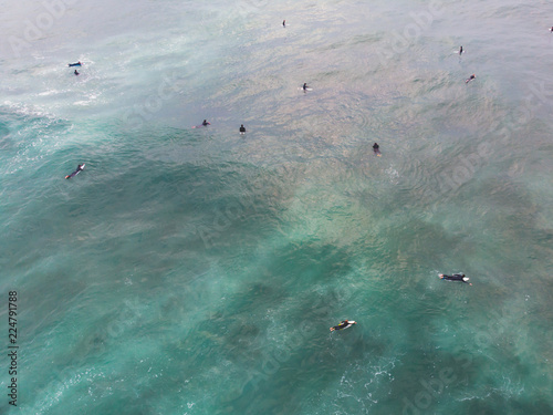 View of Praia do Guincho, Guincho beach, a popular Atlantic Ocean beach on Portugal's Estoril coast, municipality of Cascais, with surfers surfing on the waves, shot from drone