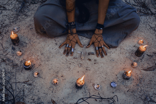 woman with candle deep in forest. Witch craft concept photo