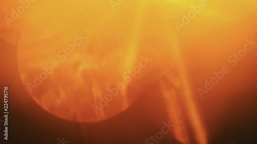 Beautiful orange light leaks in warm hue on dark background.