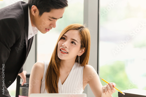 Asian couple working in office