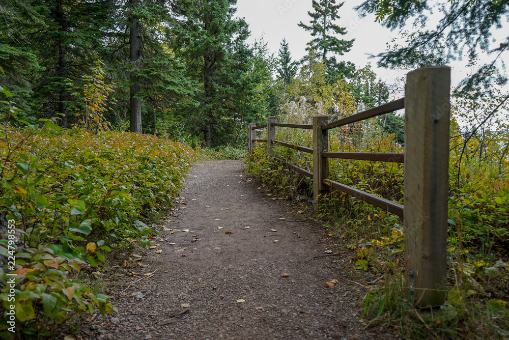 Beautiful paved trail with wooden fence at overlook on the North Shore of Lake Superior Beautiful paved trail with wooden fence at overlook on the North Shore of Lake Superior