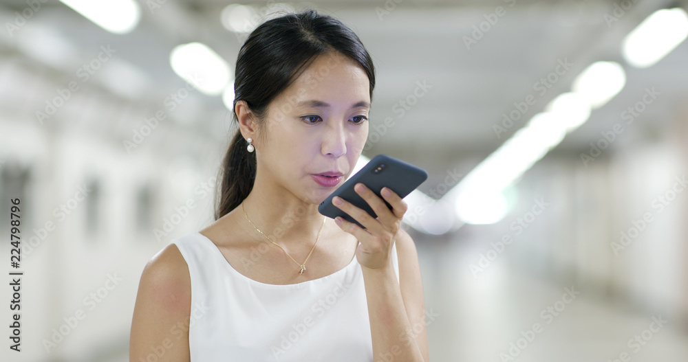 Woman sending audio message on cellphone