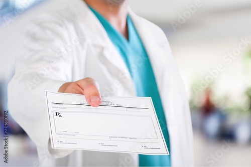 Male medicine doctor hand giving prescription photo