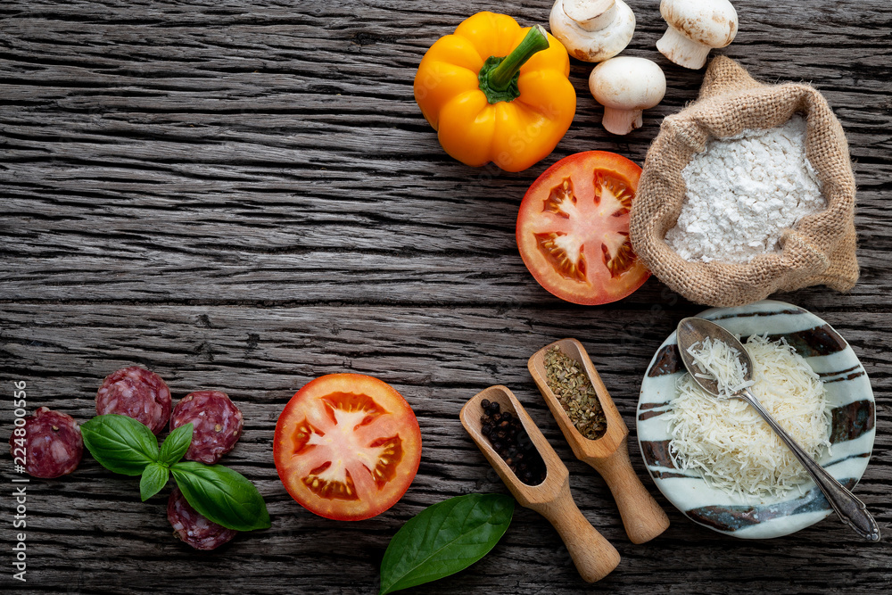The ingredients for homemade pizza on shabby wooden background. The ingredients for homemade pizza on shabby wooden background.