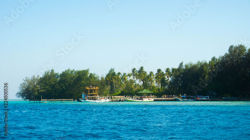 small port in remote island with wood and bamboo material with blue sea and boat