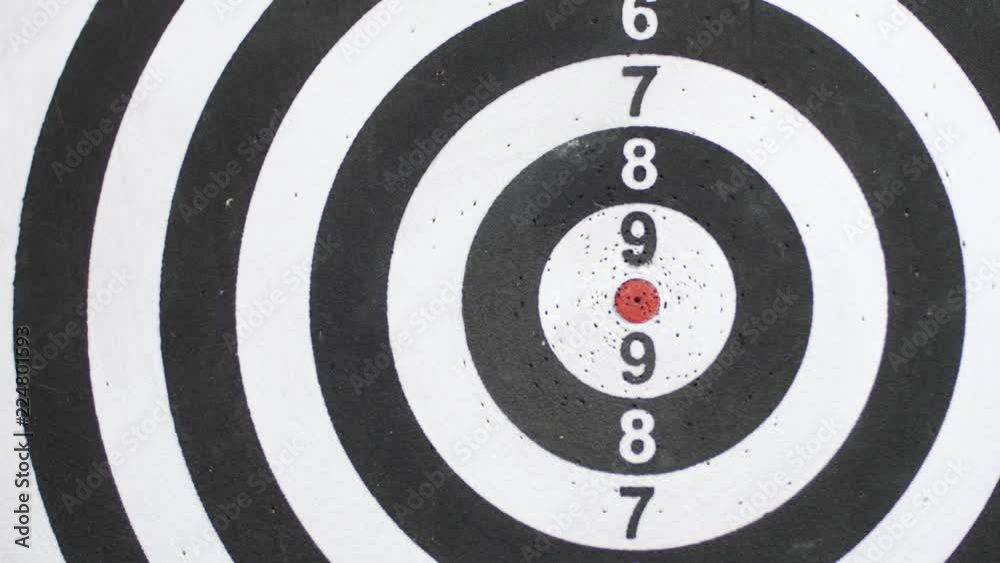 Gaming darts on black-white dartboard with five darts Gaming darts on black-white dartboard with five darts