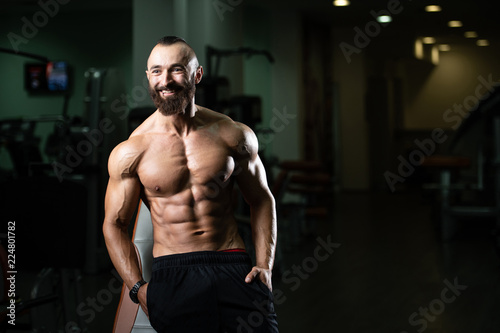 Muscular Man In Sports Outfit In Fitness Center