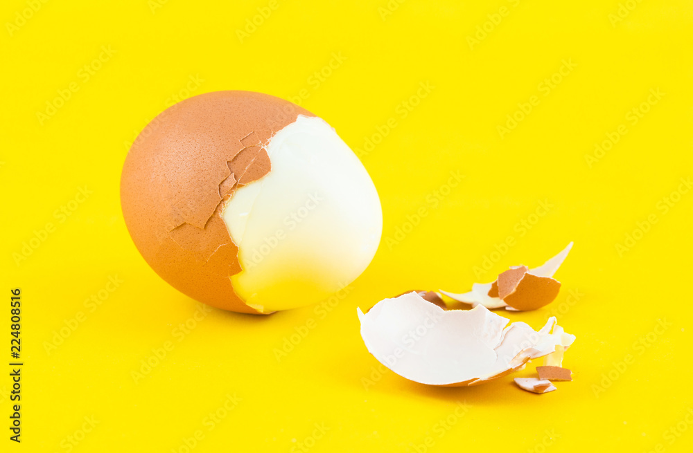 Boiled egg broken on yellow background Boiled egg broken on yellow background