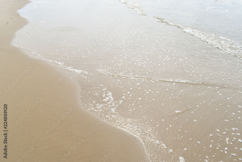 Waves washing along sand on a beach