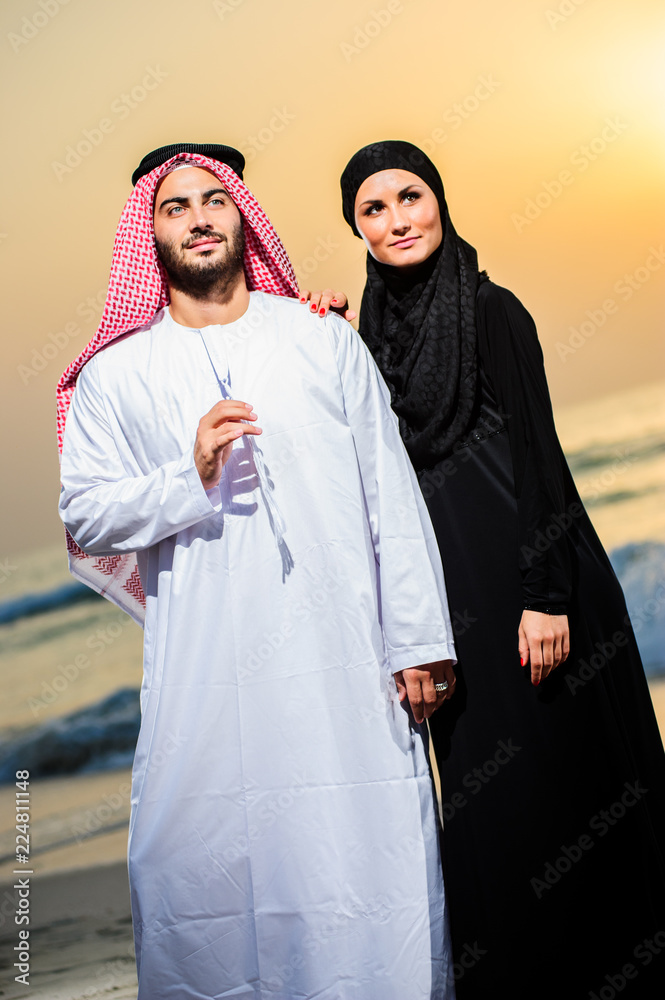 Portrait of Arabic dressed yang couple posing outdoors.