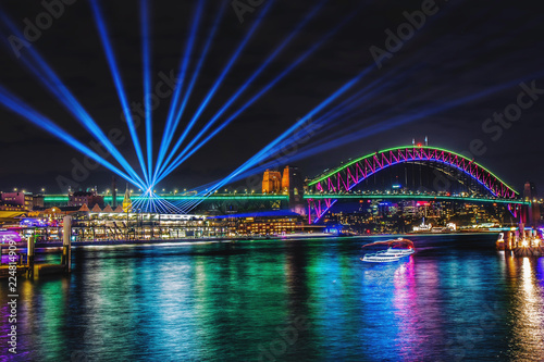 Colorful projection lights above city in night