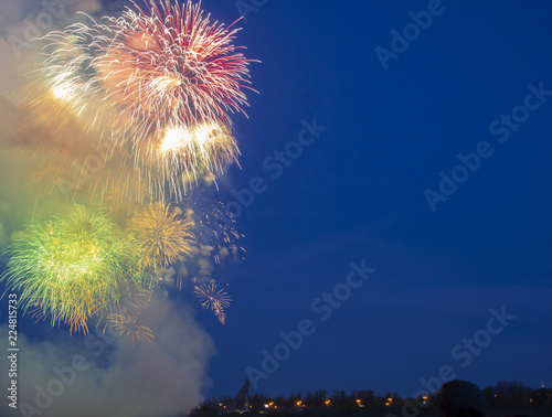 background image, rich blue sky with volleys of colorful fireworks, a place for text photo