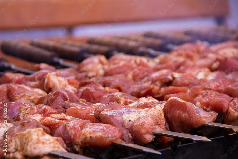 Raw barbecue is cooked on a grill with heat and smoke