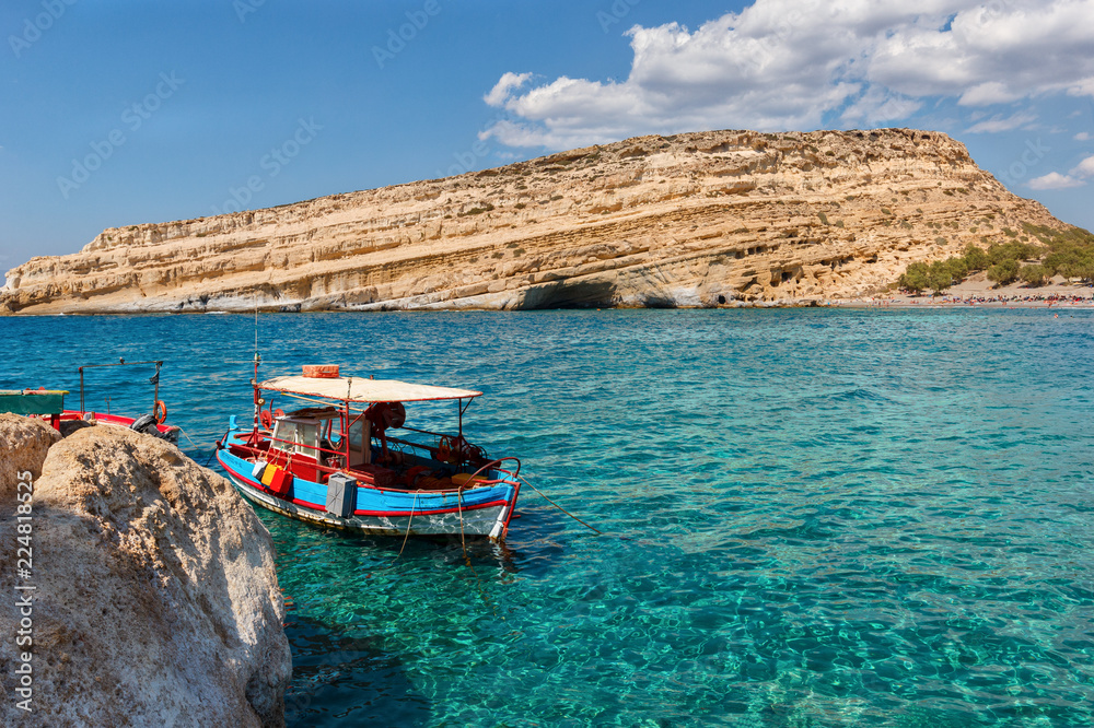 colorful boat in the beautiful turquoise sea against the white cliffs