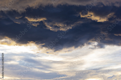 background image, black, storm clouds, illuminated by the sunset rays
