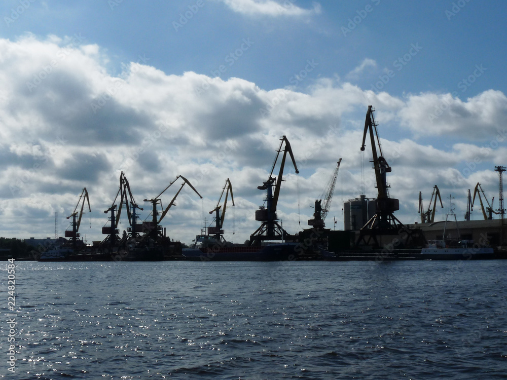 Ship with containers in port, cargo loading by crane Ship with containers in port, cargo loading by crane