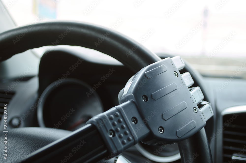Robot hand on the car steering wheel. Robot pilot is driving a car