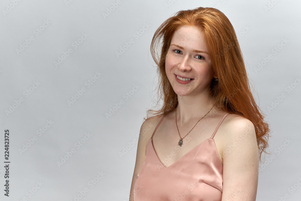 long haired young redhead woman girl with a happy expression and open smile with teeth posing for potrete on white background long haired young redhead woman girl with a happy expression and open smile with teeth posing for potrete on white background
