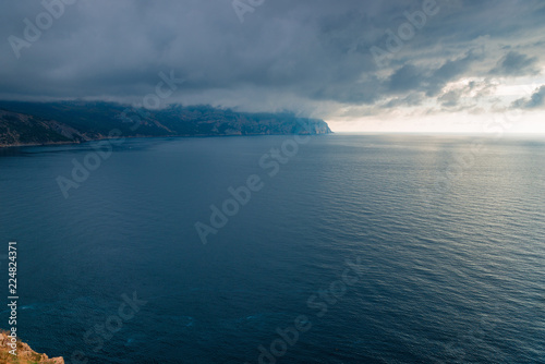 Nature before the storm - black clouds, dramatic sky above the calm sea