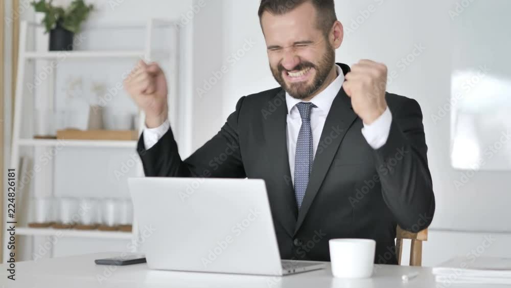 Businessman Celebrating Success, Working on Laptop Businessman Celebrating Success, Working on Laptop