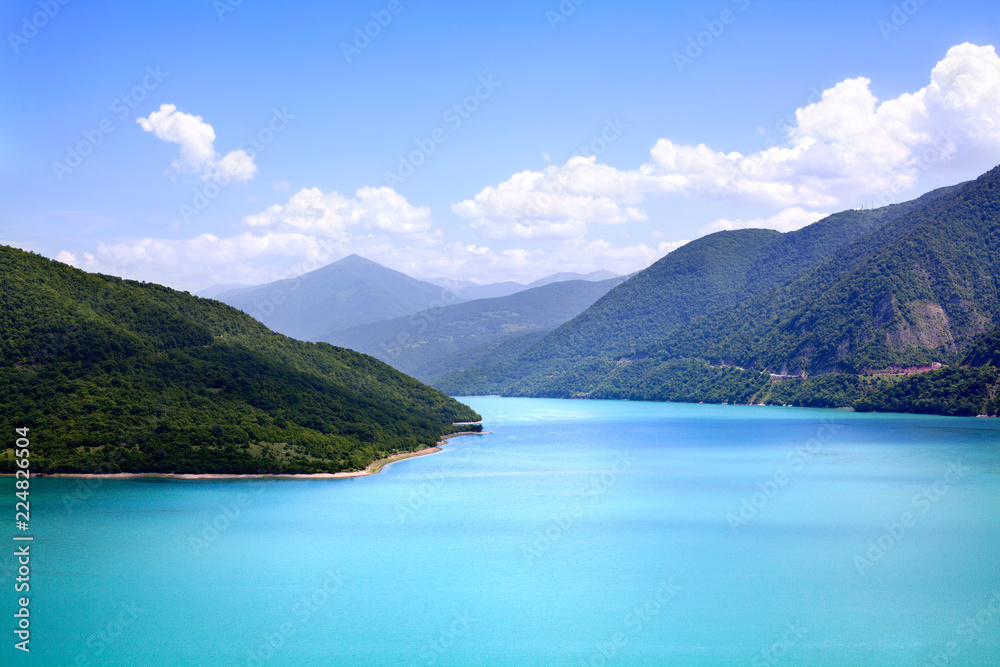 Azure water in a blue sea lagoon among green mountains blue sky white clouds background, paradise on earth, nobody