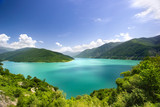 Azure water in a blue lagoon among green mountains blue sky white clouds background, paradise on earth, nobody