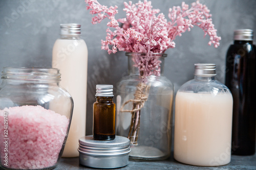 Natural spa cosmetics on a dark blue beton concrete background. Beauty blogger, minimalism concept, copy space