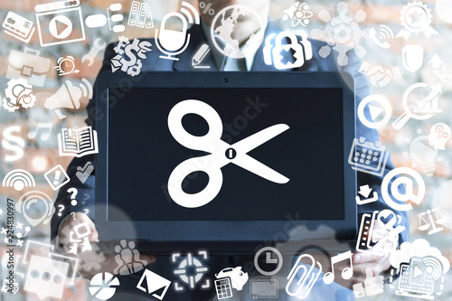 Man offers a laptop with scissors icon on a virtual doodle interface. Edit media content concept. Photo Video Music File Design Development concept.
