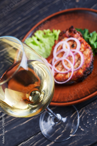 A glass of white dry wine with steak
