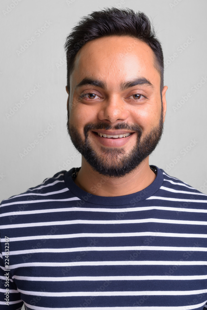Fototapeta premium Young bearded Indian man against white background