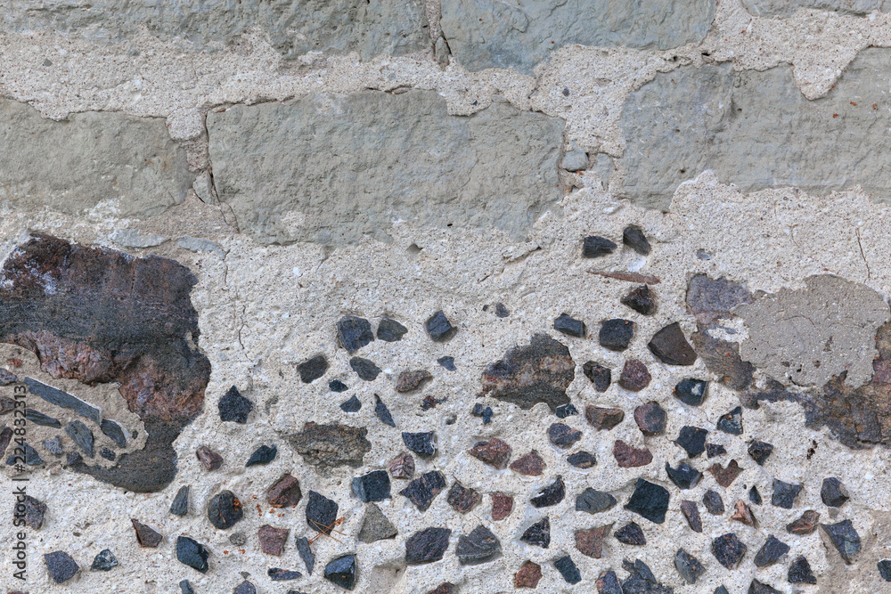 Stone Wall Background, rustic style. Texture of a fragment of masonry wall of an old house. Latvia, Europe Stone Wall Background, rustic style. Texture of a fragment of masonry wall of an old house. Latvia, Europe