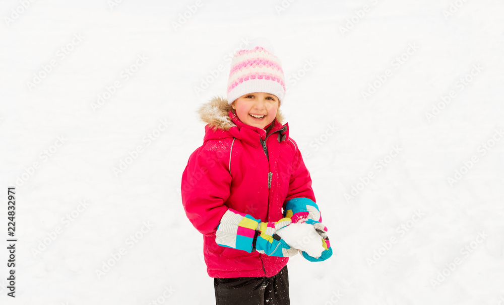 childhood, leisure and season concept - happy little girl playing with snow in winter childhood, leisure and season concept - happy little girl playing with snow in winter