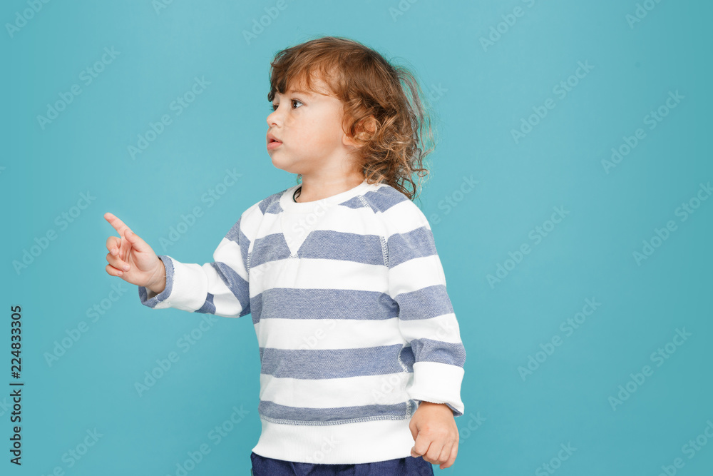 Portrait of happy joyful beautiful little boy, studio shot on blue Portrait of happy joyful beautiful little boy, studio shot on blue