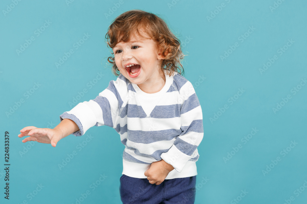 Portrait of happy joyful beautiful little boy, studio shot on blue Portrait of happy joyful beautiful little boy, studio shot on blue