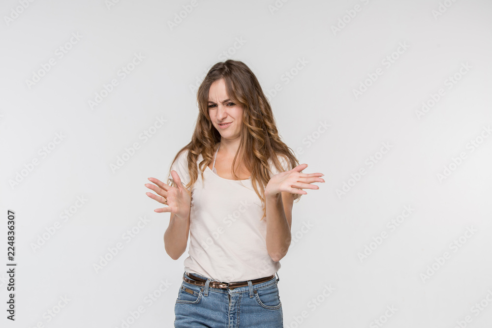 Reject, rejection, doubt concept. Doubtful woman with thoughtful expression making choice. Young emotional woman. Human emotions, facial expression concept. Front . Studio. Isolated on white Reject, rejection, doubt concept. Doubtful woman with thoughtful expression making choice. Young emotional woman. Human emotions, facial expression concept. Front . Studio. Isolated on white