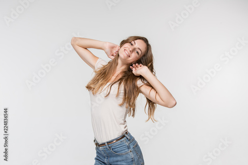 Happy business woman standing and smiling isolated on white studio background. Beautiful female half-length portrait. Young emotional woman. The human emotions, facial expression concept. Front view.