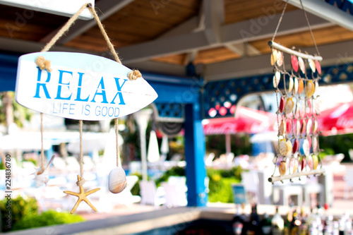 bar on the beach decorated with seashells and inscription 