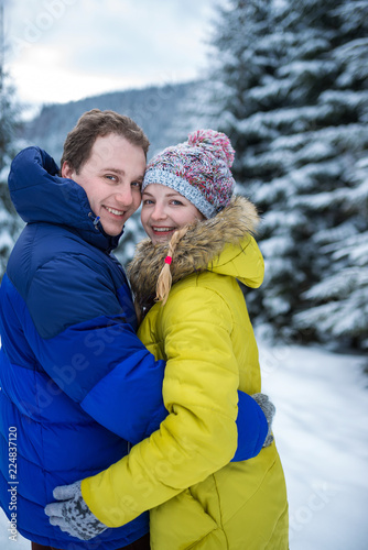  portrait of young happy couple in winter forest