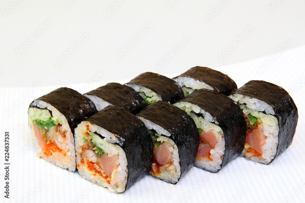 Roll with caviar of salmon. Sushi with caviar of flying fish. Japanese food on a beautiful dish. Roll with caviar of salmon. Sushi with caviar of flying fish. Japanese food on a beautiful dish.