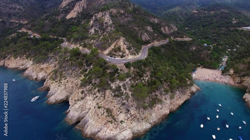 4k aerial shot of Costa Brava beach Cala Pola, Spain, Tossa de mar. Moving backwards from the road.