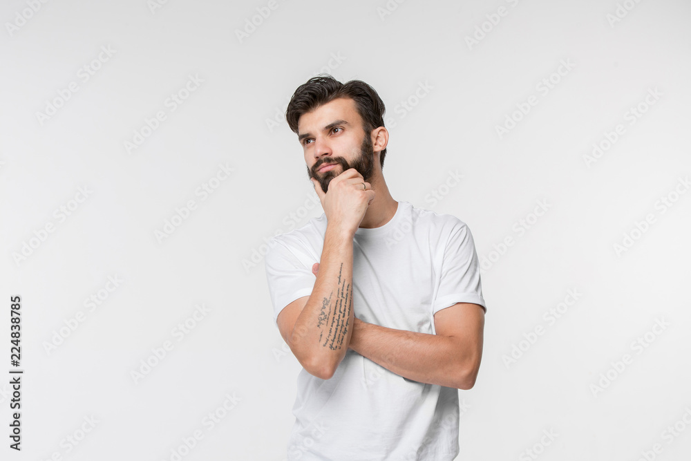 Remember all. Let me think. Doubt concept. Doubtful, thoughtful man remembering something. Young emotional man. Human emotions, facial expression concept. Studio. Isolated on white. Front Remember all. Let me think. Doubt concept. Doubtful, thoughtful man remembering something. Young emotional man. Human emotions, facial expression concept. Studio. Isolated on white. Front