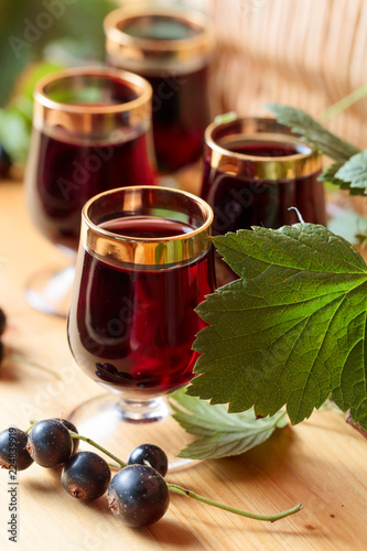 Homemade black currant liqueur and fresh berries.