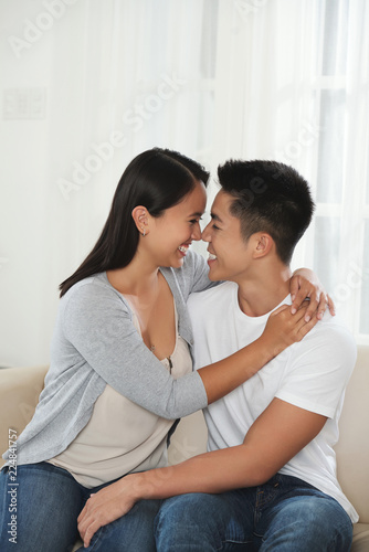 Beautiful young couple in love hugging and looking at each other