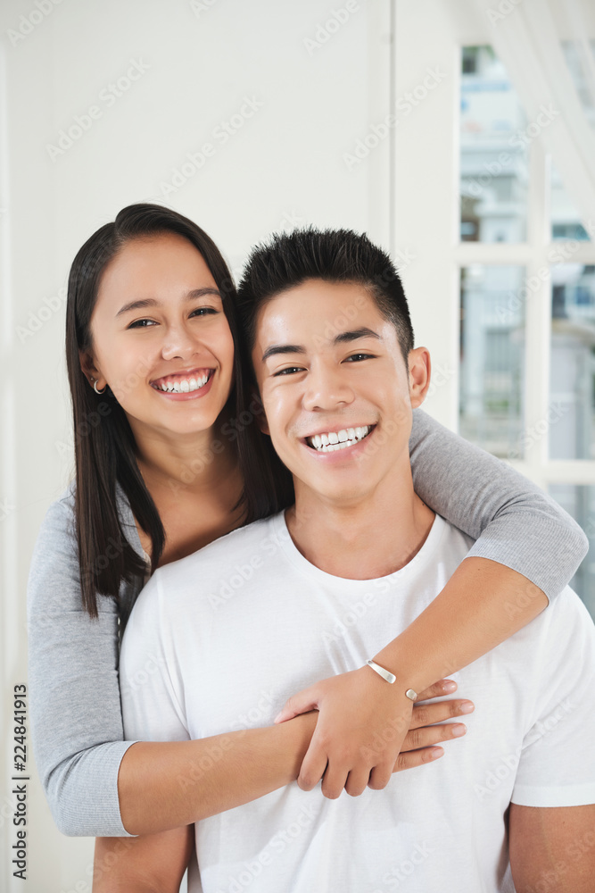Portrait of cheerful young couple in love looking at camera