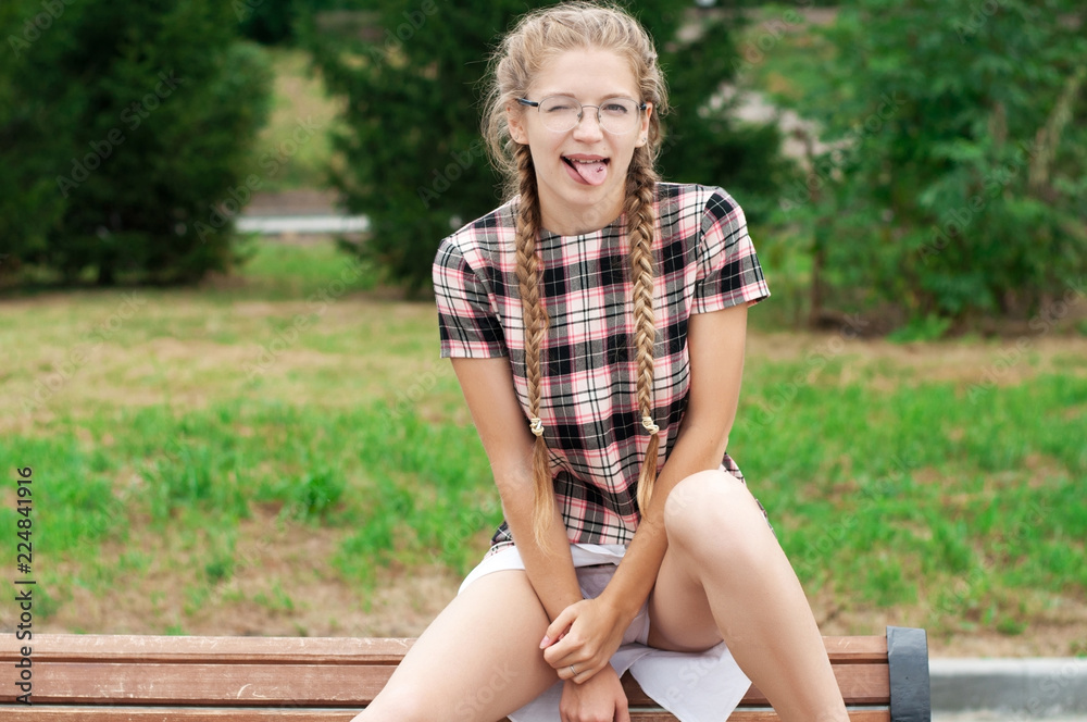 fan nerd girl in short dress in a defiant pose Stock Photo | Adobe Stock