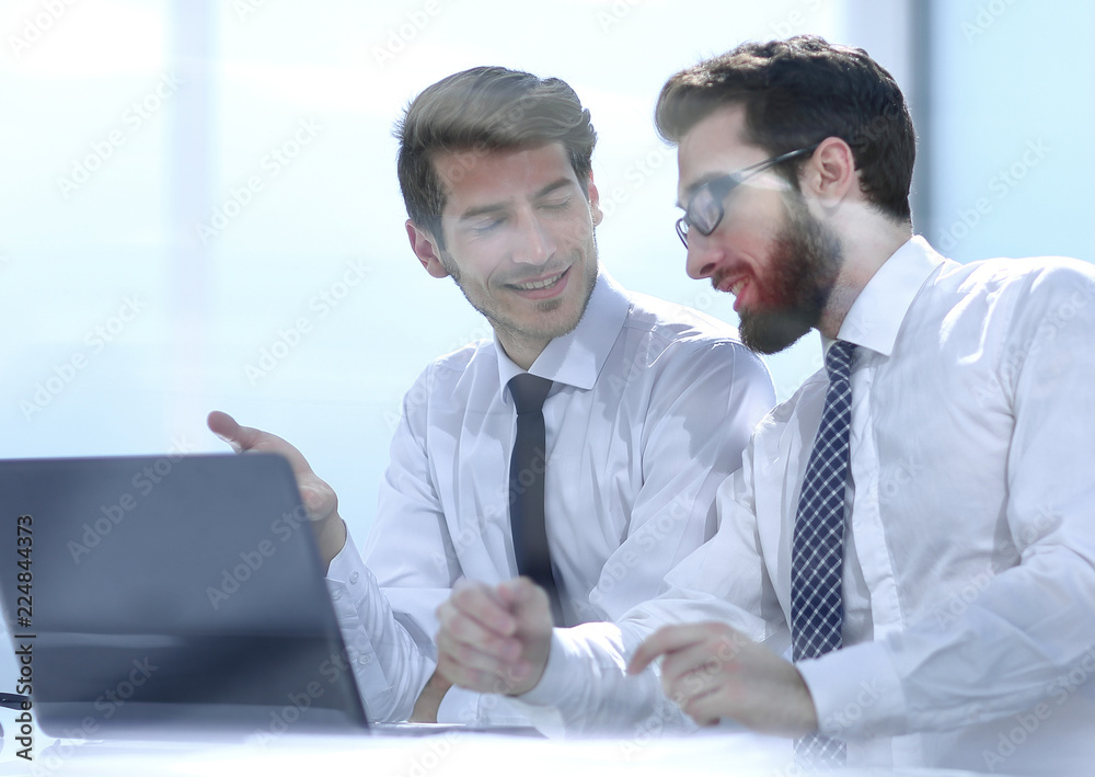 Fototapeta premium two business colleagues discuss the information sitting at the Desk